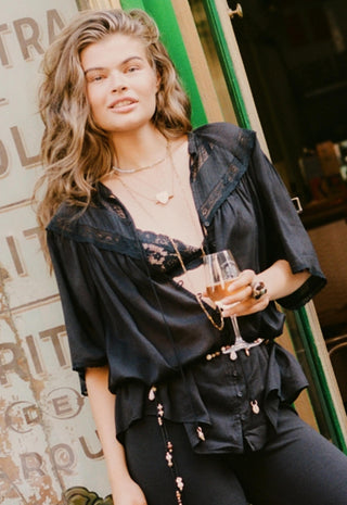  paired with black leggings and a beaded belt