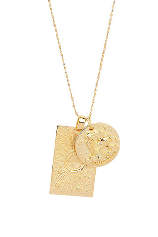 Close up front view of Spell’s Aquarius Stargazer Zodiac Necklace charms. One charm is of a rectangular shape and features a sun with stars while the other charm is circular and features the Zodiac label and icon.
